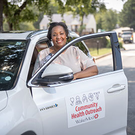 A woman smiling in a car. Links to Gifts of Cash, Checks, and Credit Cards