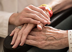 Photo of a nurse and patient hands. 